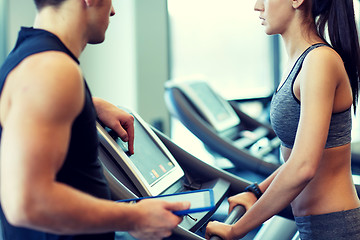 Image showing close up of woman with trainer on treadmill in gym