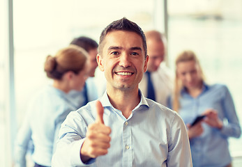 Image showing group of smiling businesspeople meeting in office