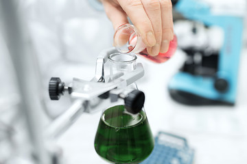 Image showing close up of scientist filling test tubes in lab