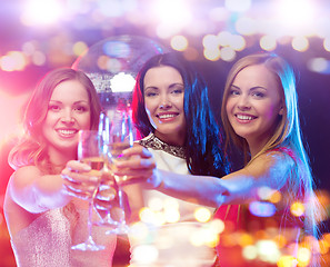 Image showing smiling women with champagne glasses at night club