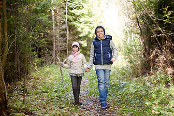 Image showing two happy kids walking along forest path