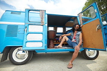 Image showing smiling young hippie man in minivan car