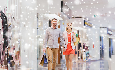 Image showing happy young couple with shopping bags in mall