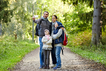 Image showing family taking selfie with smartphone in woods