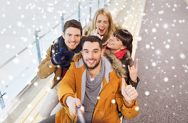 Image showing happy friends taking selfie on skating rink