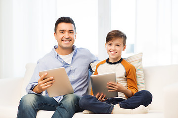 Image showing happy father and son with tablet pc at home