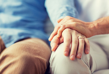 Image showing close up of happy male gay couple holding hands