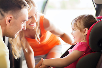 Image showing parents talking to little girl in baby car seat