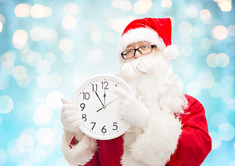 Image showing man in costume of santa claus with clock