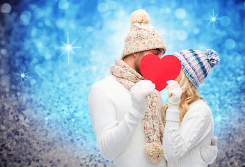 Image showing smiling couple in winter clothes with red heart