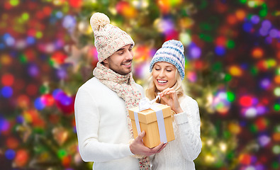 Image showing smiling couple in winter clothes with gift box