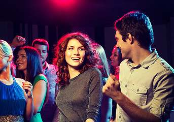 Image showing smiling friends dancing in club