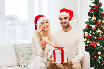 Image showing happy couple at home with christmas gift box