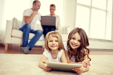 Image showing happy little girls with tablet pc computer at home