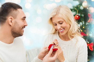 Image showing man giving woman engagement ring for christmas