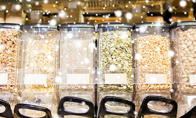 Image showing row of jars with nuts and seeds at grocery store