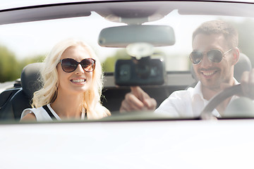 Image showing happy couple usin gps navigation system in car