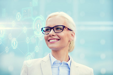 Image showing young smiling businesswoman in eyeglasses outdoors