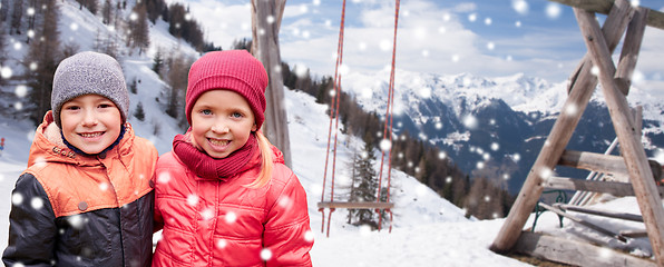 Image showing happy little girl and boy over winter