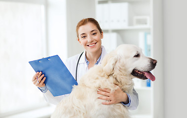 Image showing happy doctor with retriever dog at vet clinic