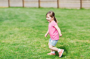 Image showing happy little girl running on green summer field