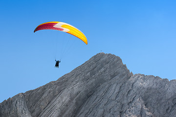 Image showing Paraglider free soaring in cloudless sky over dolomites Alpine m