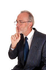 Image showing Businessman giving sign with finger over mouth.