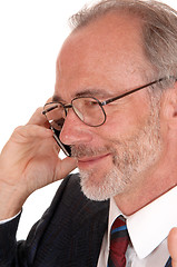 Image showing Closeuo of happy businessman on cell phone.