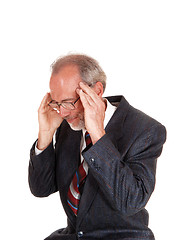 Image showing Older man in suit with headache.