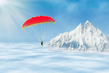 Image showing Freestyle solo paragliding over clouds against mountain peak 