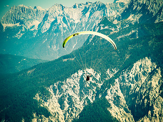 Image showing Paraglider flying over high and rugged range of Alps mountains