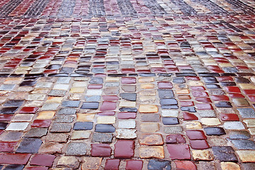 Image showing Colour wet cobblestone road in rainy weather