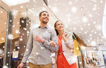 Image showing happy young couple with shopping bags in mall