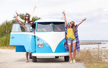 Image showing smiling young hippie friends over minivan car