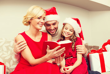 Image showing smiling family reading book