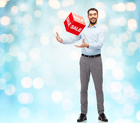 Image showing smiling man with red shopping bag