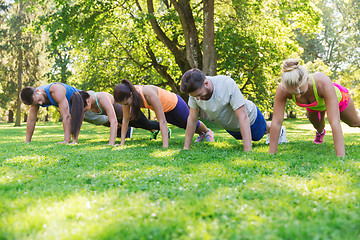 Image showing group of friends or sportsmen exercising outdoors