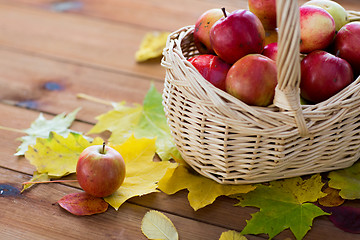 Image showing close up of basket with apples on wooden table