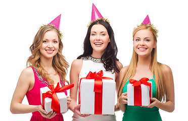 Image showing three smiling women in blue hats with gift boxes