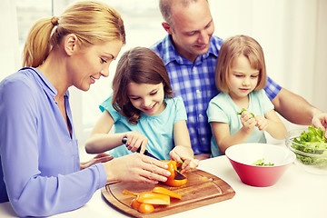 Image showing happy family with two kids cooking at home