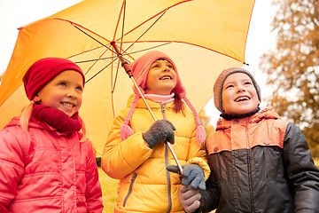 Image showing happy children with umbrella in autumn park