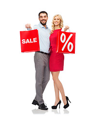 Image showing happy couple with red shopping bags