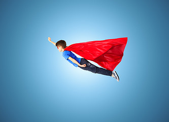 Image showing boy in red superhero cape and mask flying on air