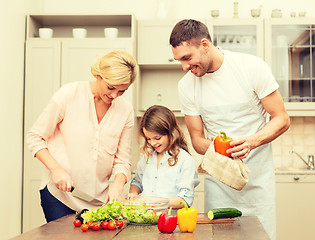 Image showing happy family making dinner in kitchen