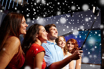 Image showing friends with smartphone taking selfie in club