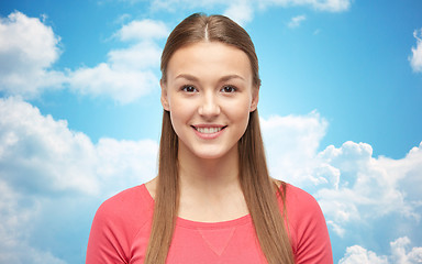 Image showing smiling young woman or teenage girl over blue sky