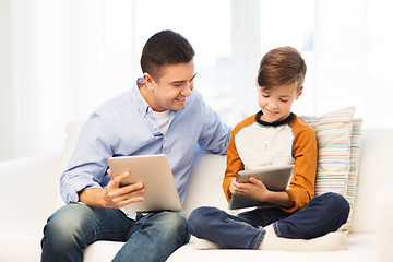 Image showing happy father and son with tablet pc at home