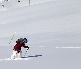 Image showing Little skier on off-piste slope with new fallen snow at nice sun