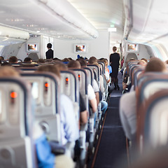 Image showing Interior of airplane with passengers on seats.
