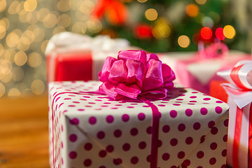 Image showing close up of gift boxes over christmas tree lights